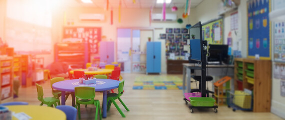 Kindergarten classroom school background. Class room for children students or nursery kids. Blur daycare preschool.