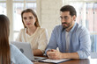 © fizkes - Concentrated two professional hr managers listening to job seeker at interview meeting in office. Group of employers involved in conversation with vacancy applicant, discussing working experience.