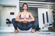 Calm female in casual wear sitting in asana pose feeling relaxation and harmony during practice, tranquil Caucasian woman with closed eyes spending time for meditation care about mind and body