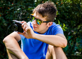 Wall Mural - Young Man with a Photo Camera