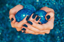 Close Up Image Of Female Hands With Perfect Blue Manicure, Holding Painted Easter Eggs