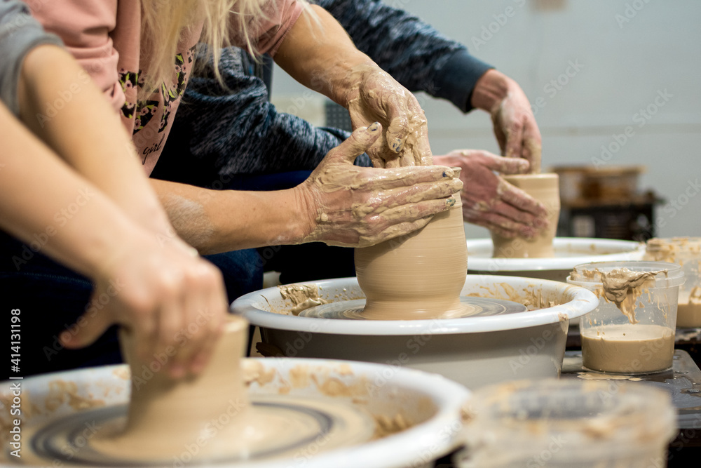 Master class on modeling of clay on a potter's wheel In the pottery workshop - obrazy, fototapety, plakaty 