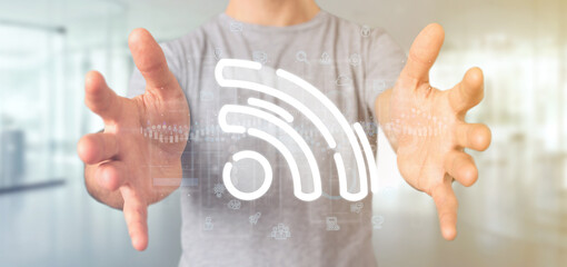 Poster - businessman holding a wifi icon with data all around