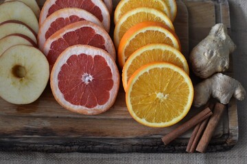 Apple, grapefruit, orange, ginger, cinnamon peel - ingredients for a winter tea, selective focus. Still life - food and drink - healthcare concept. Fall and winter traditional drinks. top view