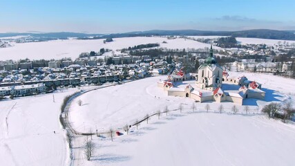 Wall Mural - Aerial drone view of Pilgrimage Church of Saint John of Nepomuk, Zdar nad Sazavou, Czech Republic. UNESCO heritage. Ancient monastery at Zelena Hora hill. Winter weather with snow, blue sky.