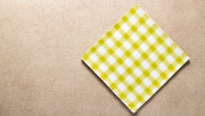 Poster - Checked or checkered tablecloth at stone surface of table. Top view of cloth napkin texture background