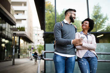 Wall Mural - Happy loving couple. Happy young man and woman having fun together in city