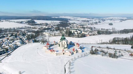 Wall Mural - Aerial drone view of Pilgrimage Church of Saint John of Nepomuk, Zdar nad Sazavou, Czech Republic. UNESCO heritage. Ancient monastery at Zelena Hora hill. Winter weather with snow, blue sky.