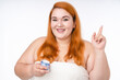 © InsideCreativeHouse - Cheerful attractive fat woman with facial cream isolated over white background
