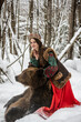 © константин константи - beautiful russian girl in national costume with a brown bear in the winter forest