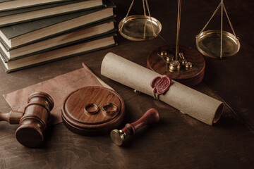 Divorce concept. Judge gavel and golden rings in notary public office.