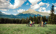 © Halfpoint - Family with small children cycling outdoors in summer nature, Tatra mountains Slovakia.