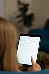 Women reading e-book, watching news, browsing internet or digital app. Home office. 