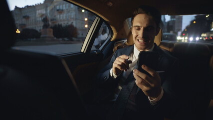 Angry business man giving instructions in video chat in luxury automobile.