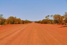 A Long, Straight, Rough Red Dirt Road In The Outback Of The Northern Territory Of Australia