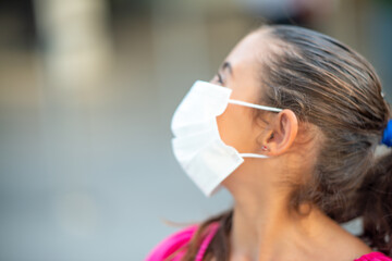 Sticker - Beautiful caucasian young girl outdoor wearing face mask, side view