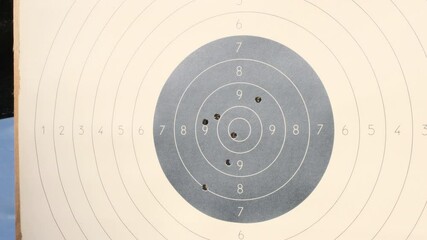 Wall Mural - The target for shooting is pierced by bullets in the shooting range. Target for practical pistol shooting with bullet holes. Range shooting practice.