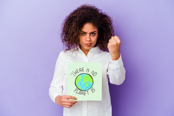 Wall Mural - Young African American woman holding a There is no planet B placard isolated showing fist to camera, aggressive facial expression.