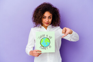 Wall Mural - Young African American woman holding a There is no planet B placard isolated showing a dislike gesture, thumbs down. Disagreement concept.