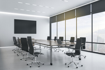 Blank black tv screen on white wall in modern conference room with stylish furniture and city view. Mockup