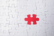 © New Africa - White jigsaw puzzles and red one as background, top view