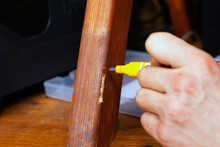 Restoration And Repair Of Wooden Furniture The Master Hand Closes The Scratch With A Special Marker