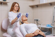 © Semachkovsky  - Master beautician conducting stimulating electric facial treatment. Microcurrent therapy. Cosmetic self-care. Beauty industry concept