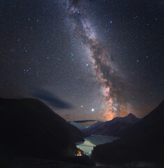 Wall Mural - photograph of the night sky. milky way over a mountain lake. there are many small stars throughout t