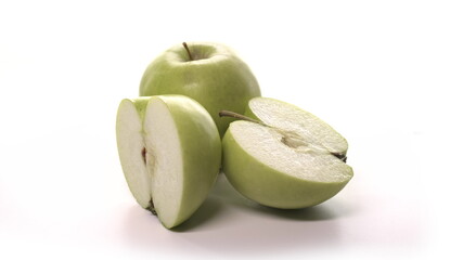 Two fresh cutted green apples are spinning on white background. Freshly picked sour or sweet cut apples granny smith on turntable detailed view isolated.