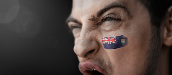 A screaming man with the image of the Saint Helena national flag on his face