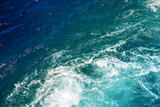 Fototapeta  - Turquoise blue sea with foamy trail. Motorboat trail on blue ocean surface. Cruise liner or ship tail on sea