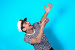 © Denis - Funny experienced sailor ready for marine travel. Cheerful young sailor. Expression of emotions. The guy is posing on a blue background.