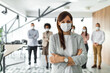 © bnenin - Business group of people, standing behind female boss.