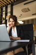 © bnenin - Portrait of a pensive businesswoman reading something on laptop in the office.
