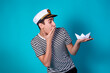 © Denis - Funny experienced sailor ready for marine travel. Cheerful young sailor. Expression of emotions. The guy is posing on a blue background.