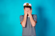 © Denis - Funny experienced sailor ready for marine travel. Cheerful young sailor. Expression of emotions. The guy is posing on a blue background.