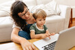 © (JLco) Julia Amaral - Small boy learning using laptop with mom