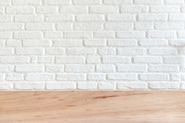  White brick background On a wooden surface. For placement of work pieces to present