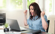 © thodonal - Young woman getting good news on laptop