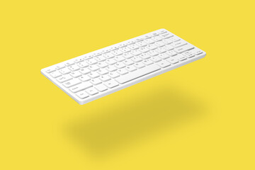 . White computer keyboard levitating on yellow background, shadow visible. The concept of modern digital technologies, online work, training, sales, etc.