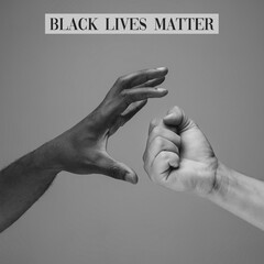 Wall Mural - Black lives matter. African and caucasian hands gesturing on gray studio background. Tolerance and equality, unity, support, kindly coexistence together concept. Worldwide multiracial community.