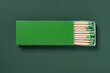 © Freer - green matchbox and green match sticks on a green background