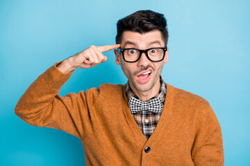 Wall Mural - Photo of irritated young unhappy man point index finger head disbelief isolated on blue color background