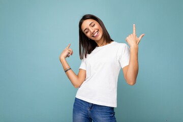 Wall Mural - Photo of young positive happy smiling beautiful woman with sincere emotions wearing stylish clothes isolated over background with copy space