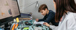 © David Pereiras - Mother helping her son with his homework while teleworking