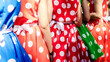 Group of teen girls in colorful dresses with polka dots. Retro fashion of red and blue dresses with white polka dots.