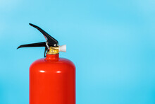 Closeup View Color Stock Photography Of New Red Fire Extinguisher Isolated On Blue Background