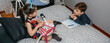 © David Pereiras - Children playing and doing homework talking with their mother who works at home