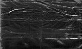 Background texture of a polyethylene,plastic transparent black plastic film,transparent stretched background