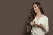 © millaf (Nemchinova) - Beautiful healthy woman enjoying coffee on brown banner background